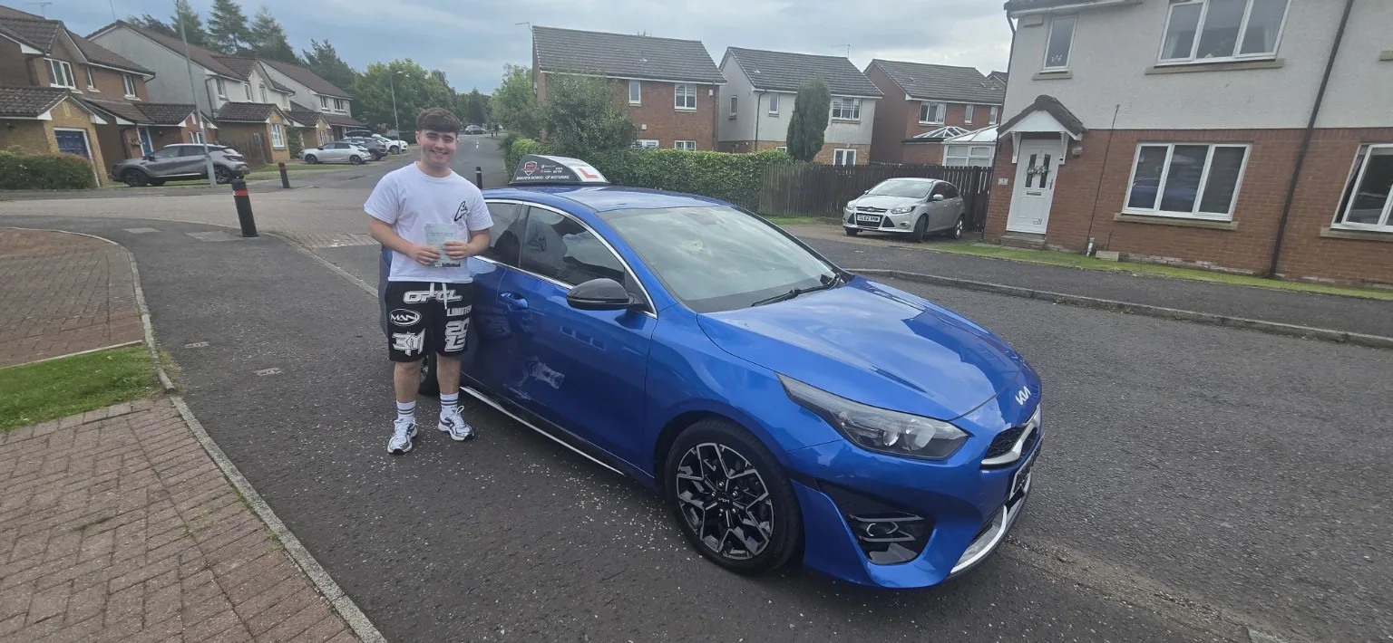 Successful Bravo's pupil beside blue learner car